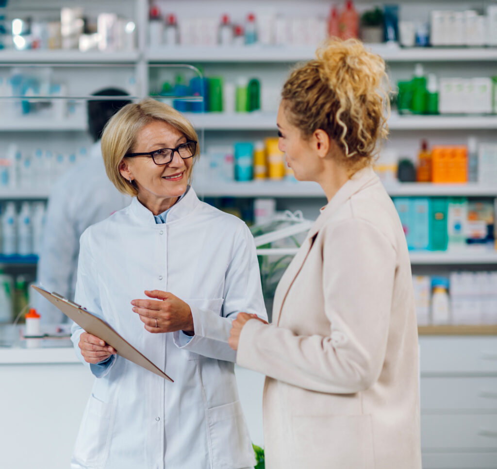 Portrait of a senior woman pharmacist and a female customer in a
